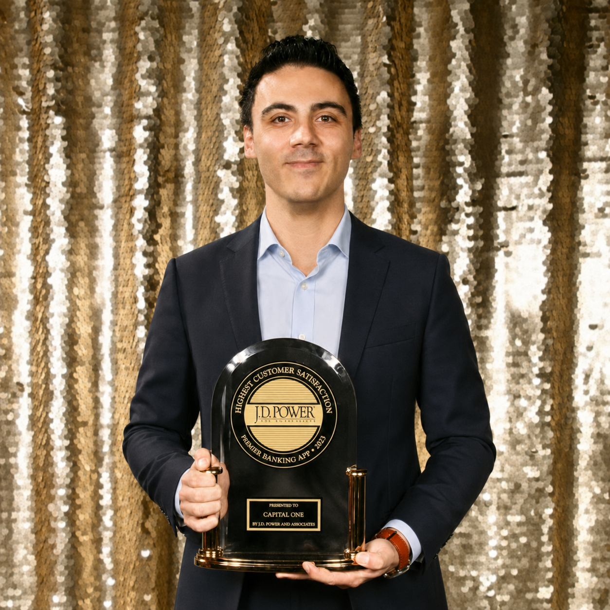 Cem Bas holding a J.D. Power award